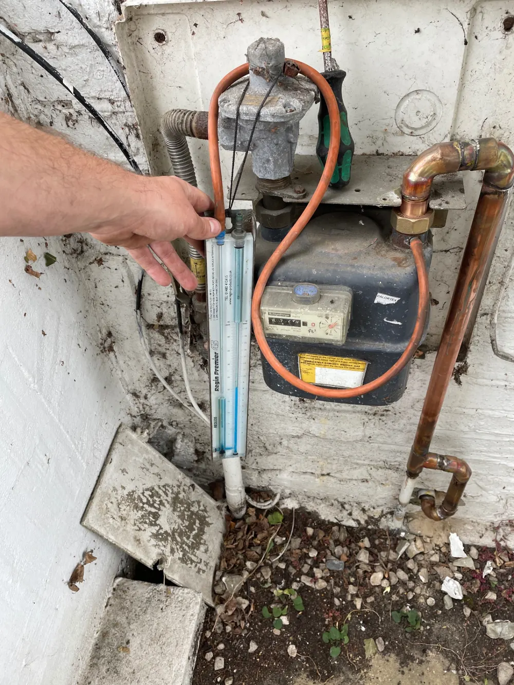 Gas Safe engineer carrying out a gas working pressure test at an external gas meter